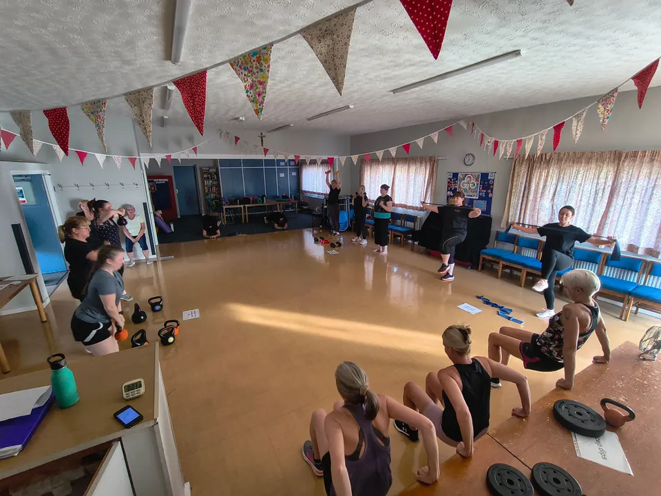 Class members exercising at different circuit stations