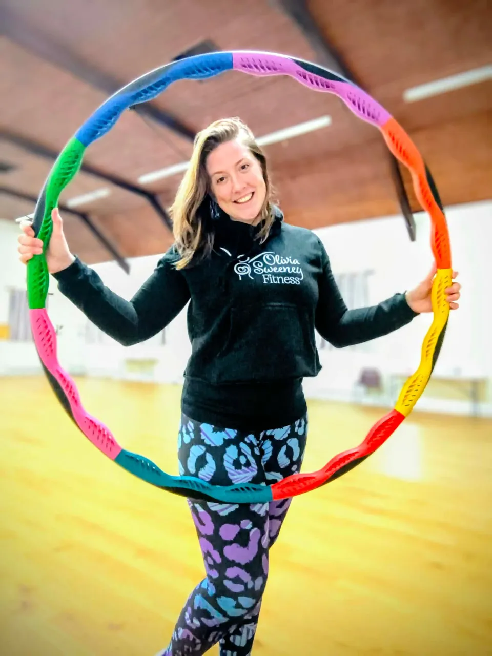 Liv smiling inside a colourful Powerhoop
