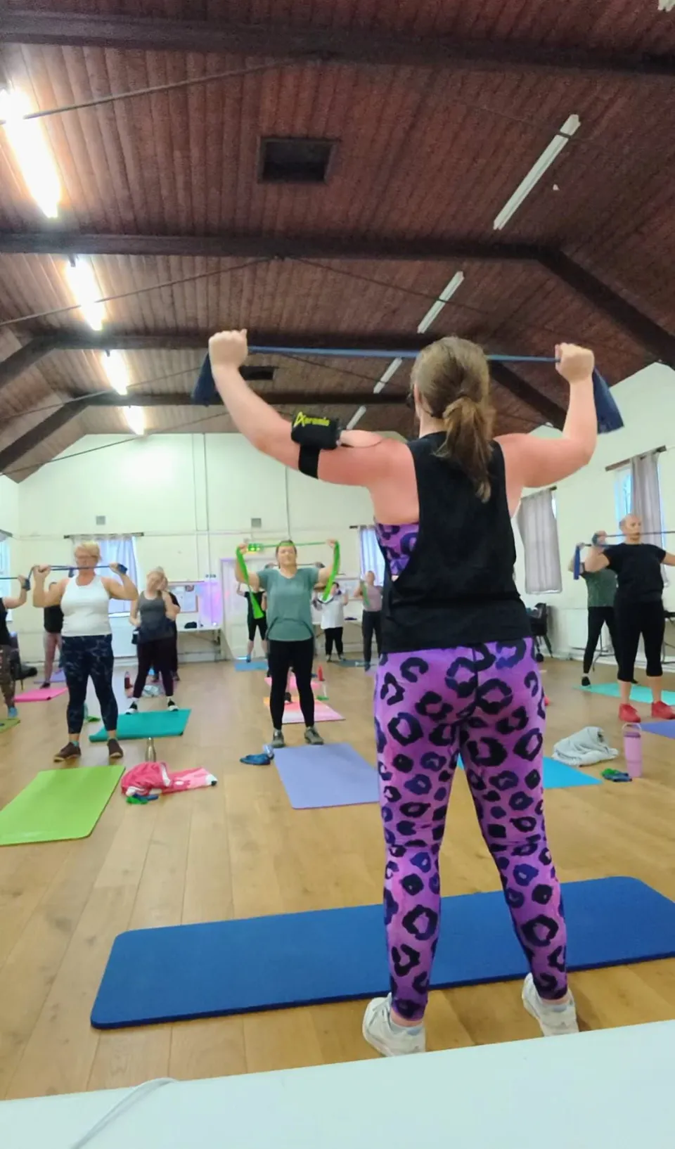 Liv leading a PowerPause class with resistance bands